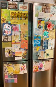 Photo of a refrigerator with cards on it.