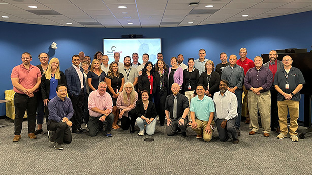 A group photo of Travelers leaders at an event.