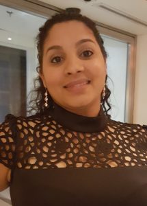 Woman smiling at camera in a black shirt.