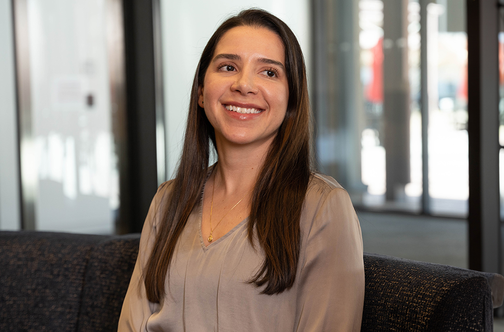 A young woman smiles as she has a conversation