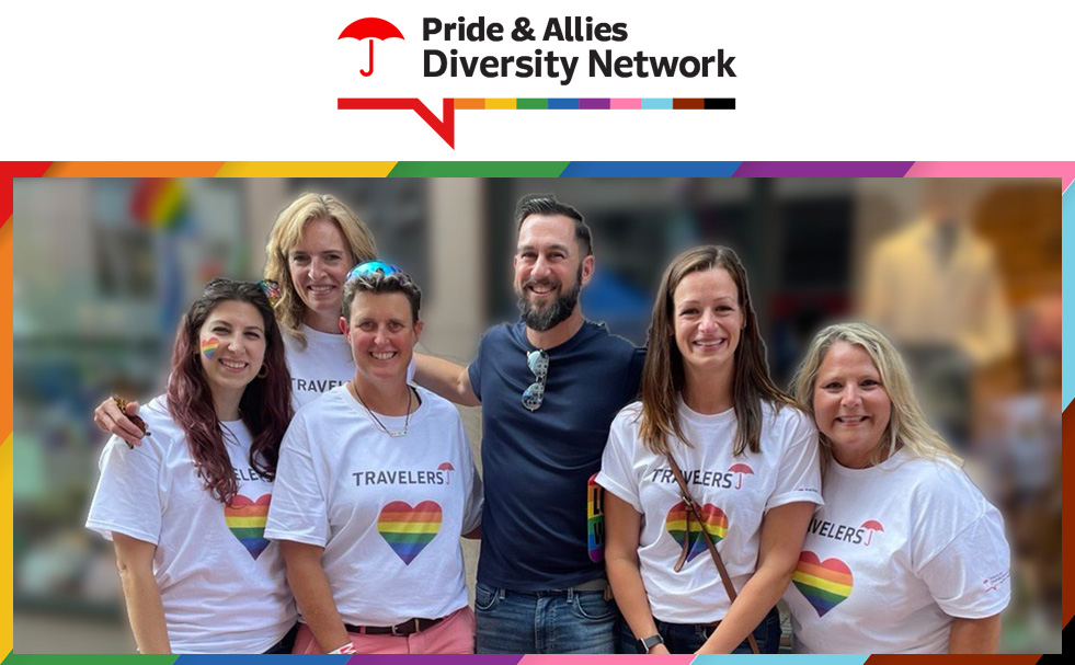 Pride & Allies Diversity Network. Group of employees celebrating in Travelers shirts with rainbow hearts.