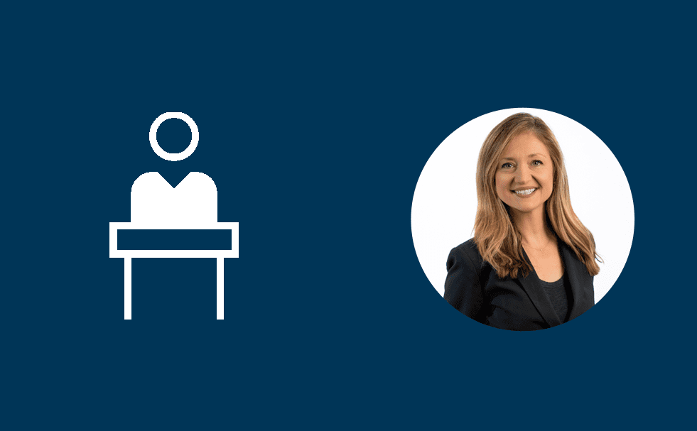 Professional headshot of a smiling blonde woman wearing a black blazer, positioned on the right side within a white circular frame. On the left side, there is a simple white icon depicting a person standing behind a podium or lectern. The background is dark blue, creating a corporate or professional design.